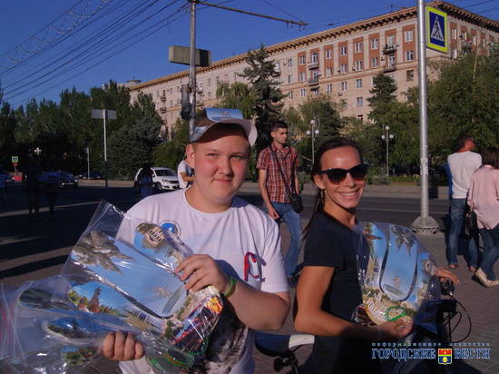 Волонтеры дарят гостям Волгограда сувенирные кепку, веер и браслет
